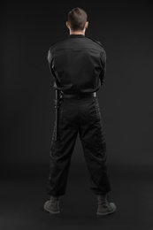 Photo of Male security guard in uniform on dark background