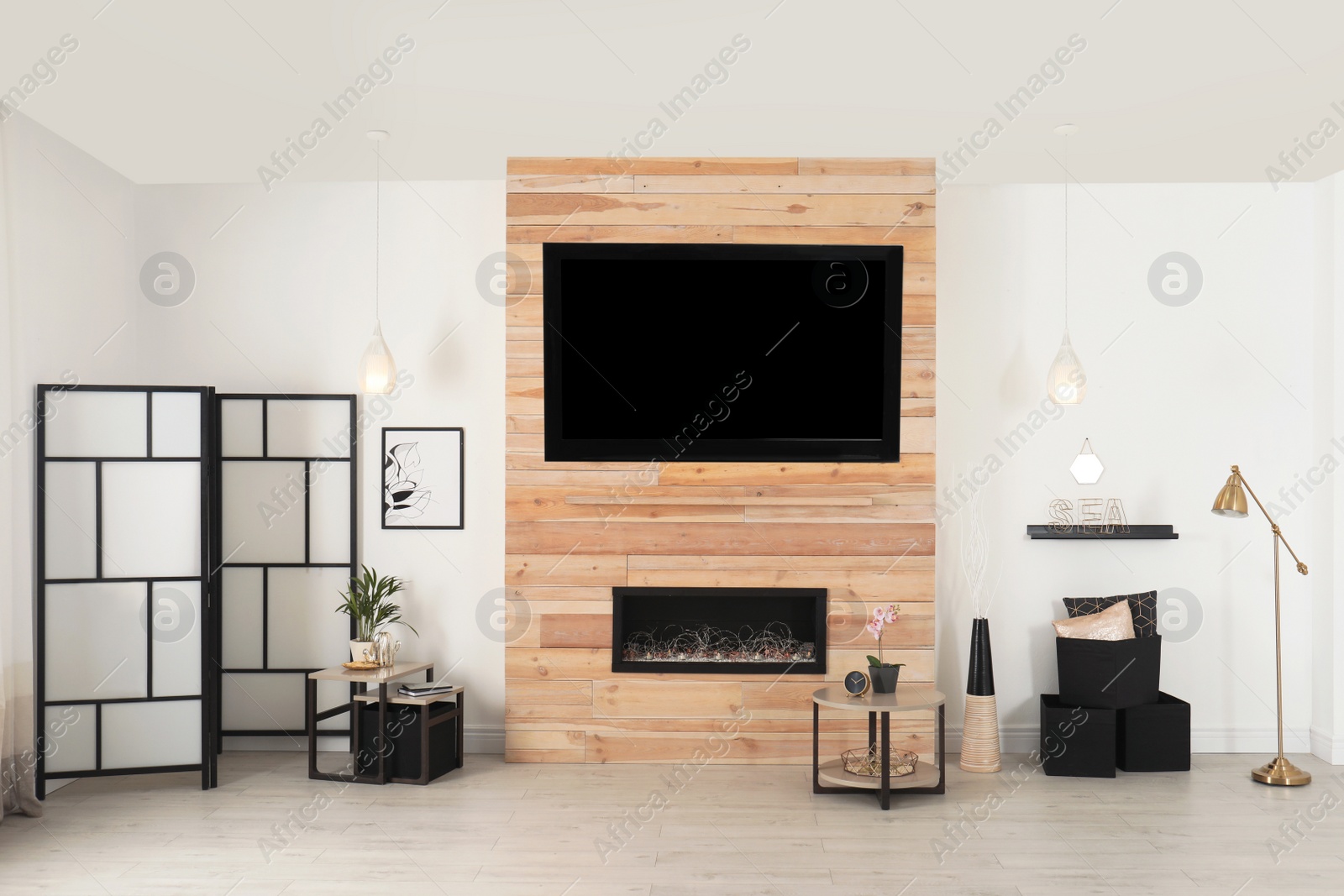 Photo of Living room interior with decorative fireplace in wooden wall