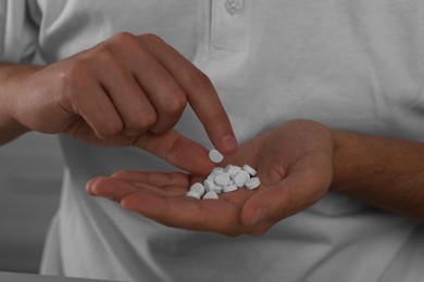 Photo of Closeup view of man with antidepressant pills