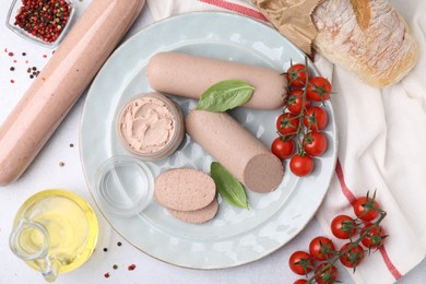 Photo of Delicious liver sausages, paste and cherry tomatoes on light grey table, flat lay