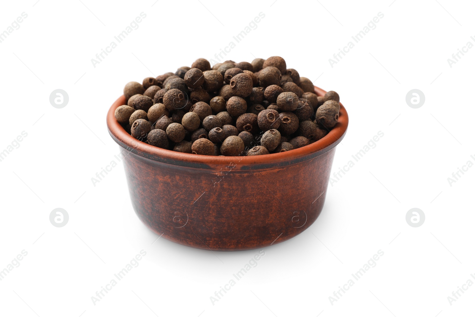 Photo of Aromatic allspice pepper grains in bowl isolated on white