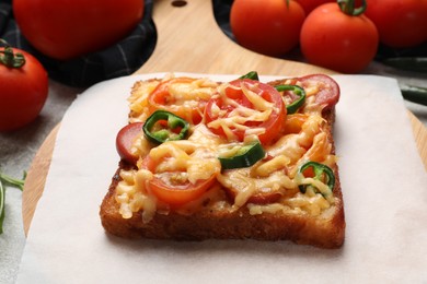 Tasty pizza toast and tomatoes on table, closeup