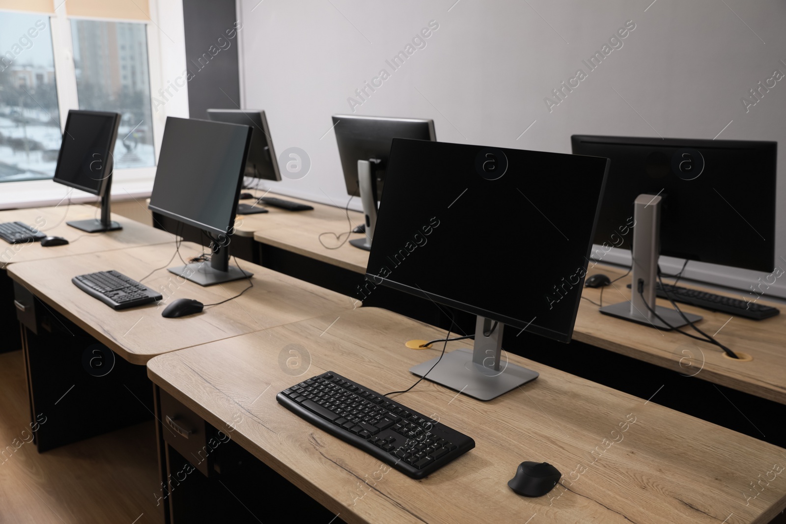 Photo of Many modern computers in open space office