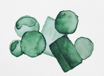 Photo of Green watercolor circles and rectangles on white background, top view