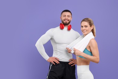 Photo of Athletic people with headphones and towel on purple background, space for text