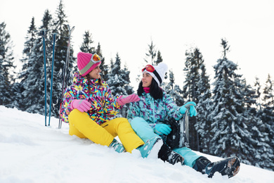 Photo of Friends with equipment on snowy hill. Winter vacation