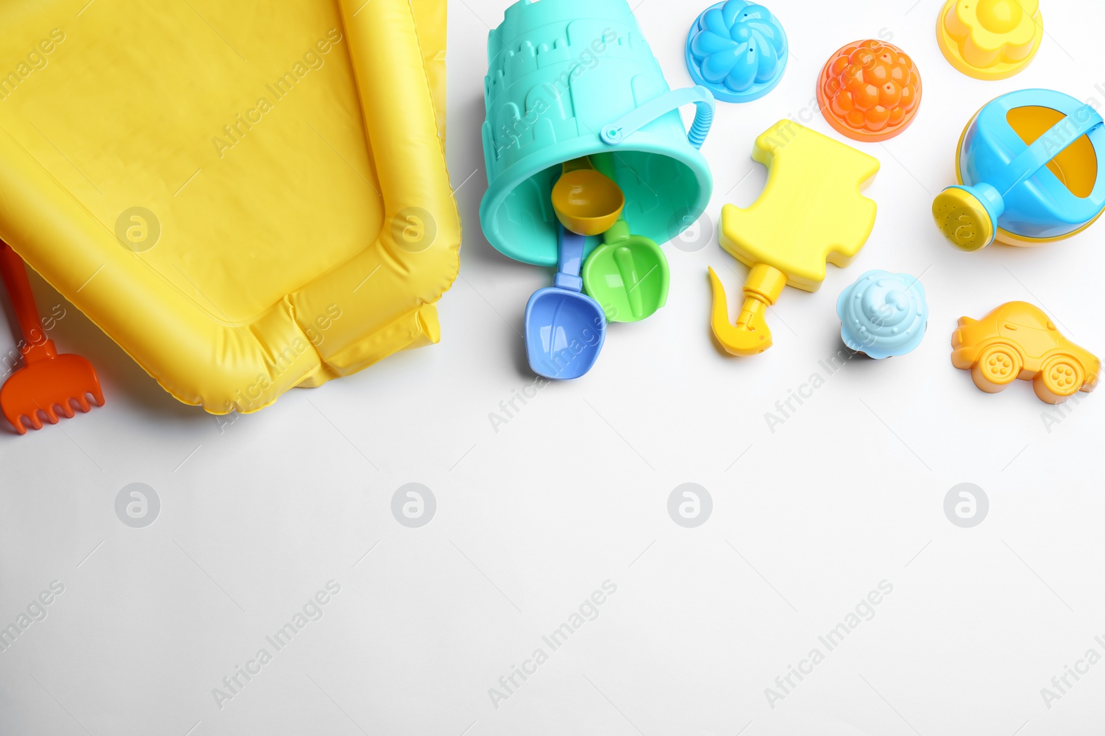 Photo of Composition with bright beach toys on white background, top view