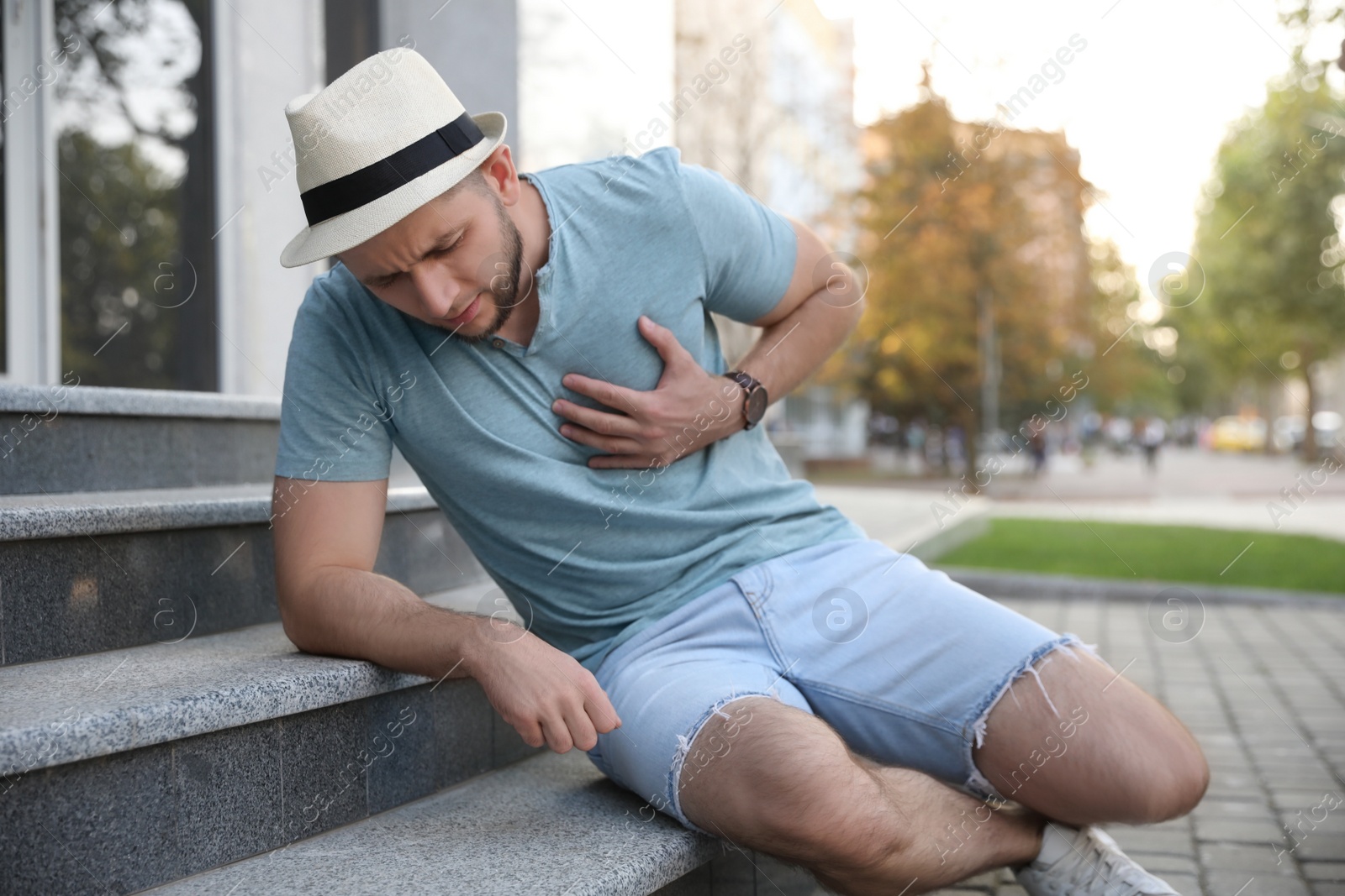 Photo of Man having heart attack on city street