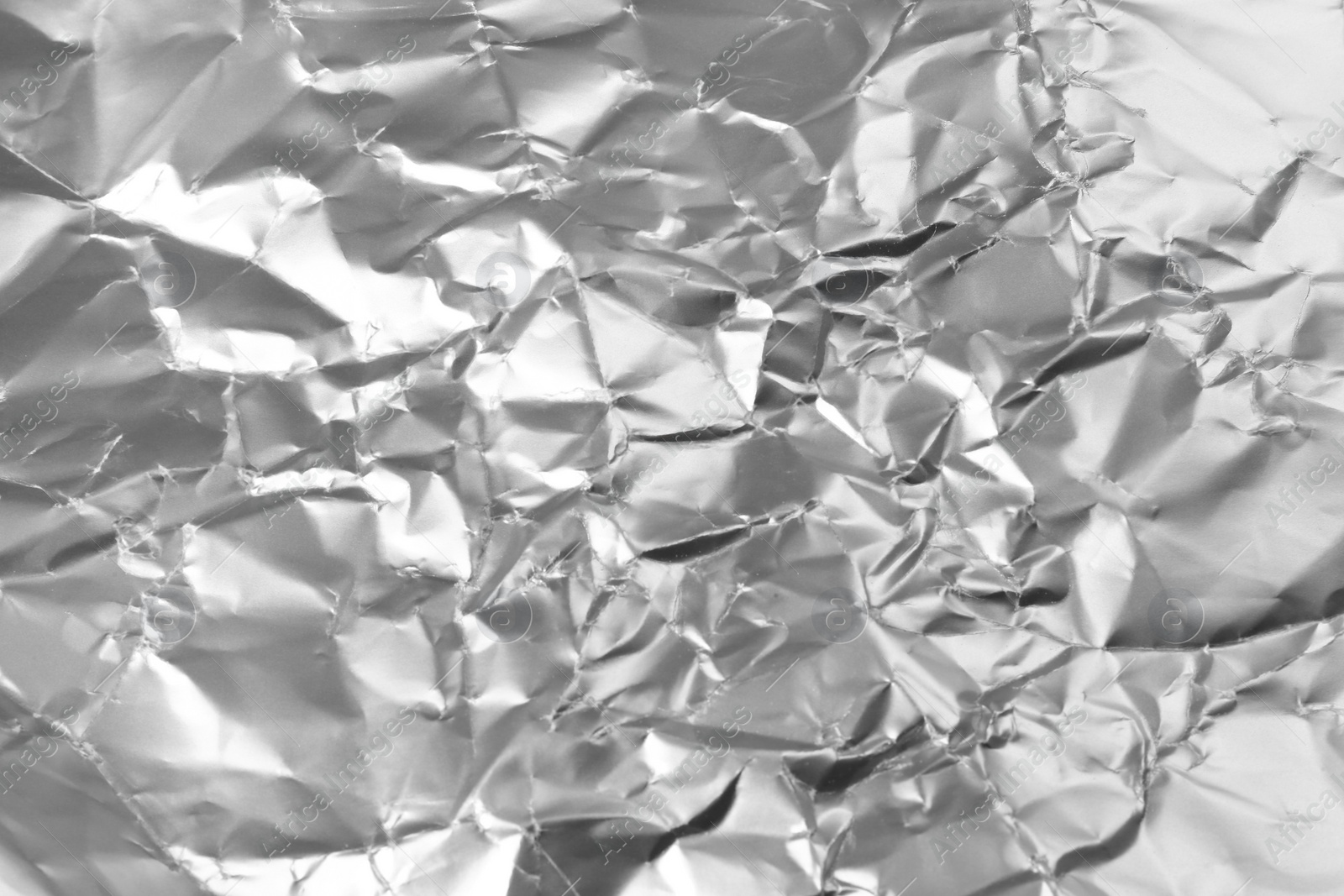 Photo of Crumpled silver foil as background, closeup view