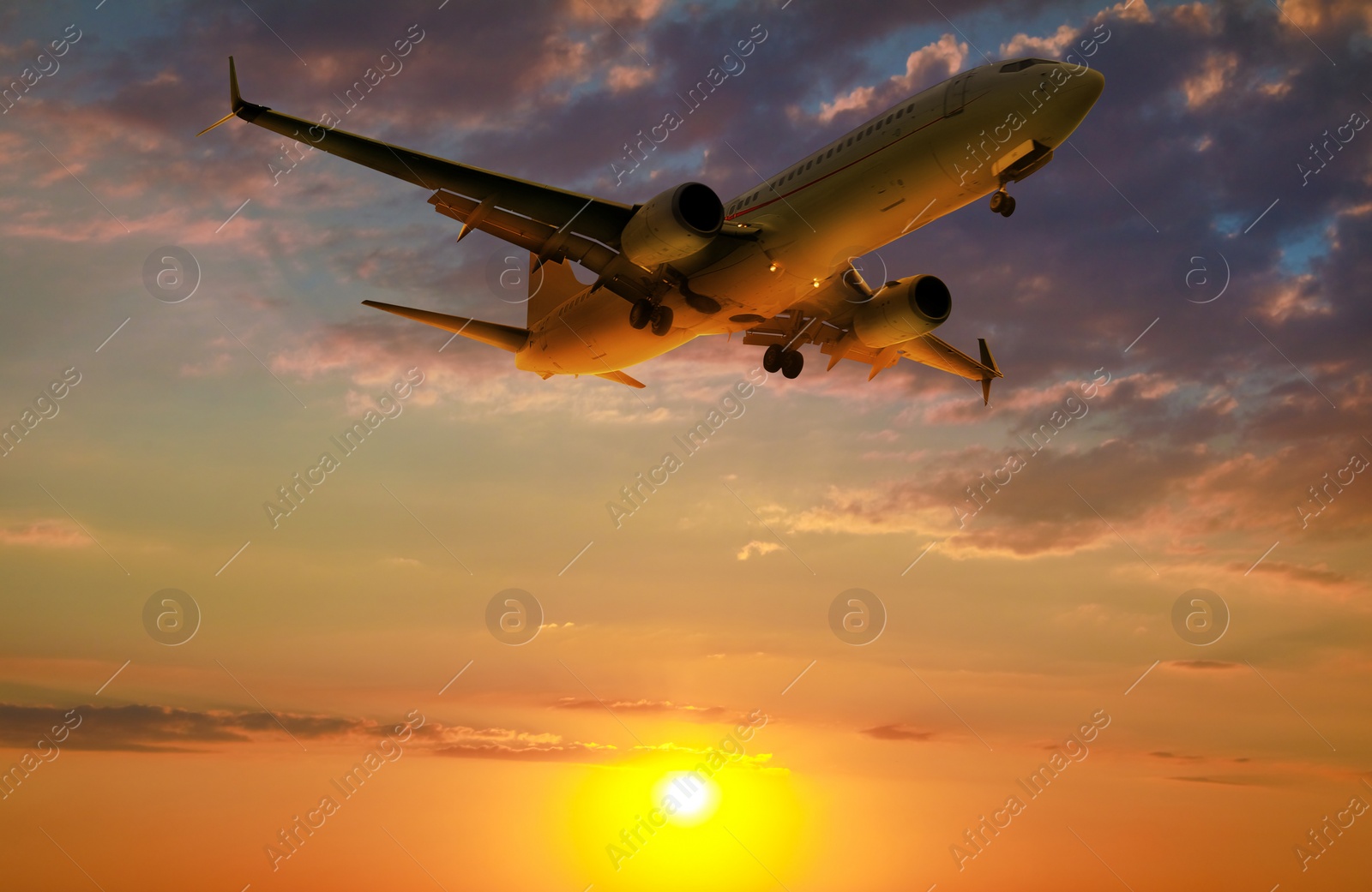 Image of Plane in sky during sunset, low angle view