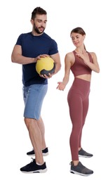 Photo of Athletic couple doing exercise with medicine ball on white background