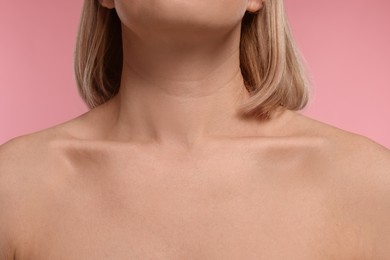 Photo of Woman with healthy skin on pink background, closeup