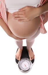 Photo of Pregnant woman standing on scales against white background, closeup