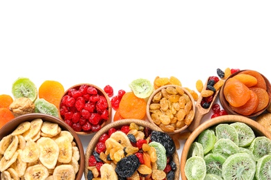 Bowls with different dried fruits on white  background, top view. Healthy lifestyle