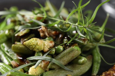 Photo of Delicious tarragon and baked vegetables on table, closeup