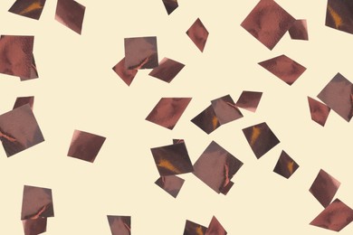 Image of Shiny bronze confetti falling on beige background