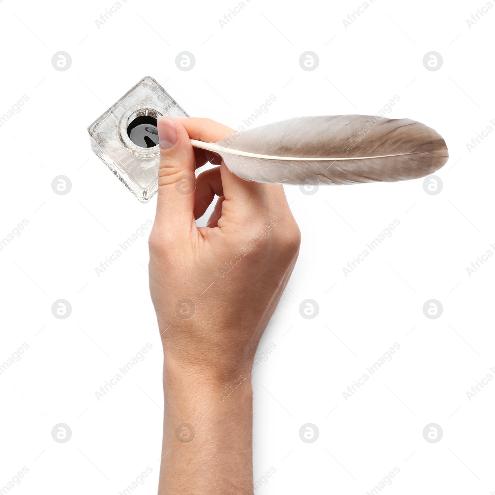 Photo of Woman dipping feather pen into inkwell on white background, top view