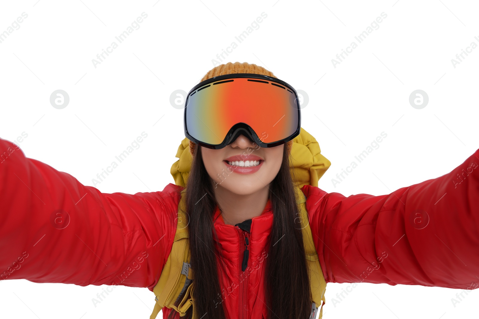 Photo of Smiling woman in ski goggles taking selfie on white background