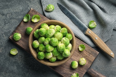 Composition with bowl of Brussels sprouts on grey background, flat lay