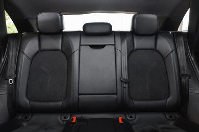 Clean leather seats inside of modern black car