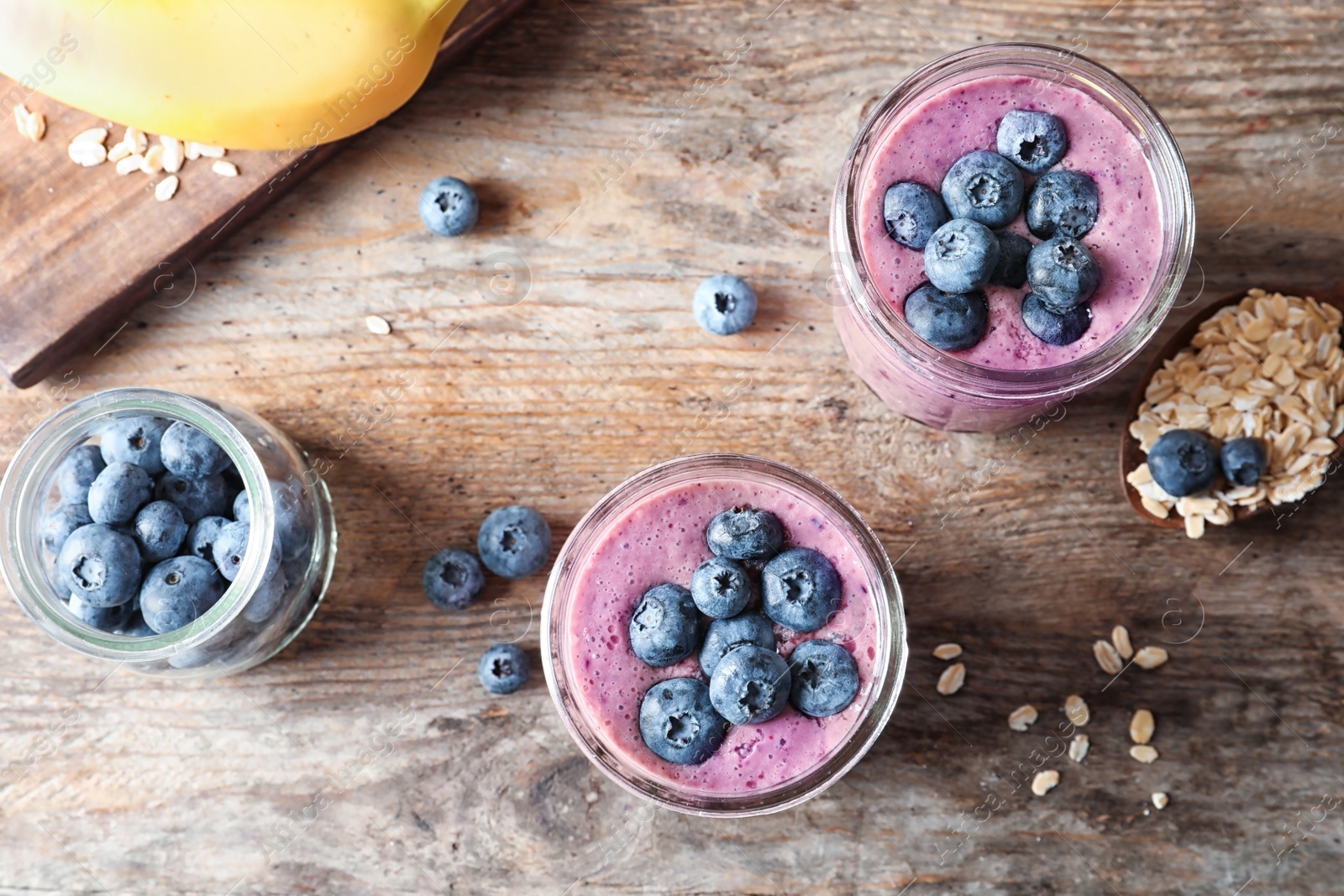 Photo of Flat lay composition with blueberry smoothies on wooden background