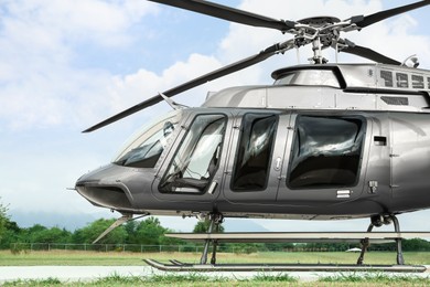 Photo of Beautiful modern helicopter on helipad in field