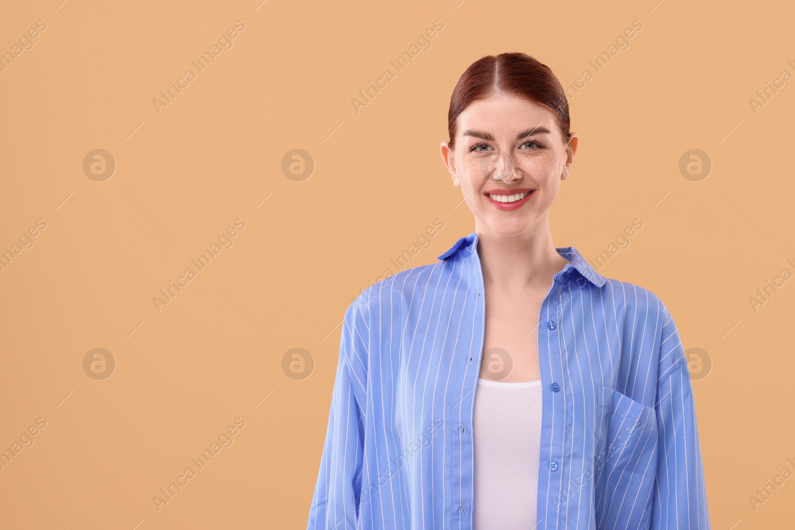 Photo of Portrait of smiling woman on beige background. Space for text