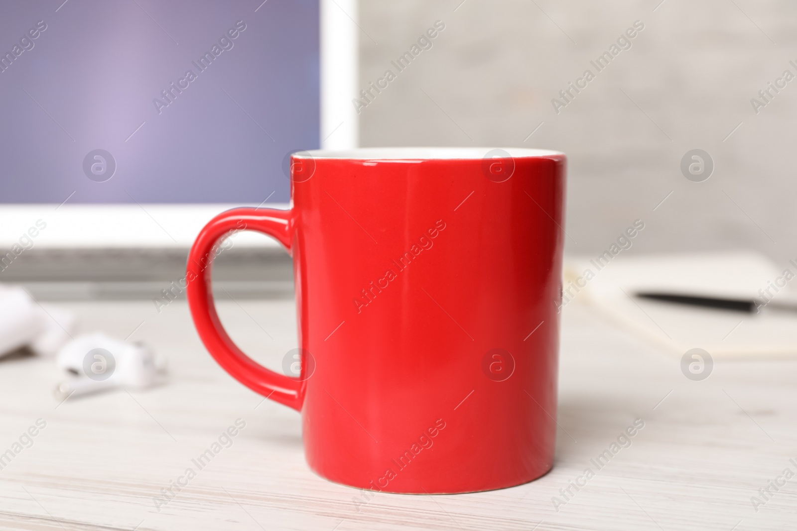 Photo of Mug of hot drink on white wooden table in office. Coffee Break