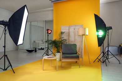 Stylish furniture in photo studio with professional equipment