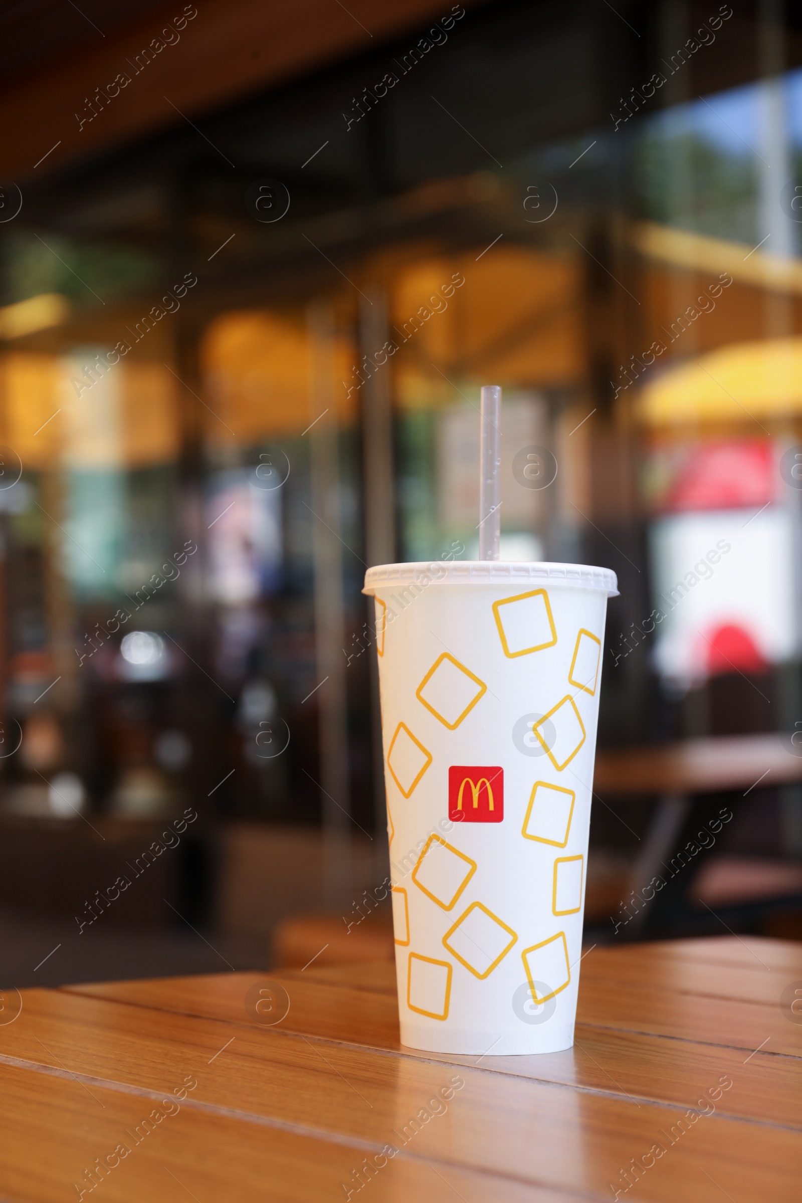 Photo of MYKOLAIV, UKRAINE - AUGUST 11, 2021: Cold McDonald's drink on table in cafe