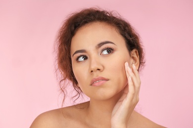 Photo of Beautiful young woman with acne problem on color background