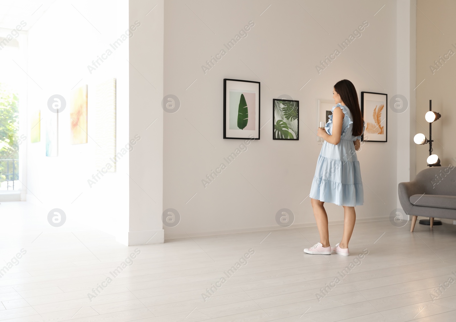 Photo of Young woman at exhibition in art gallery