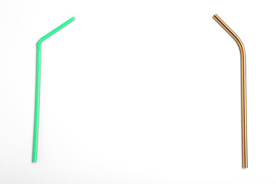 Photo of Plastic and metal drinking straws on white background, top view. Recycling concept