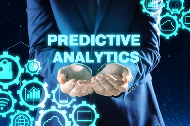 Image of Concept of predictive analytics. Businessman and different virtual icons on dark background, closeup