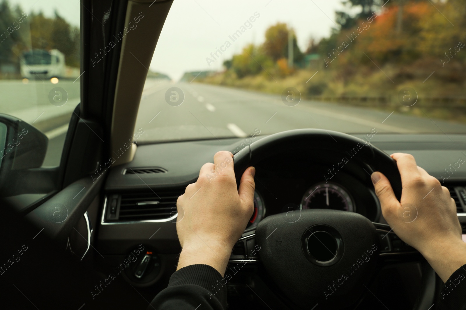 Photo of Man driving his car, closeup. Traffic rules