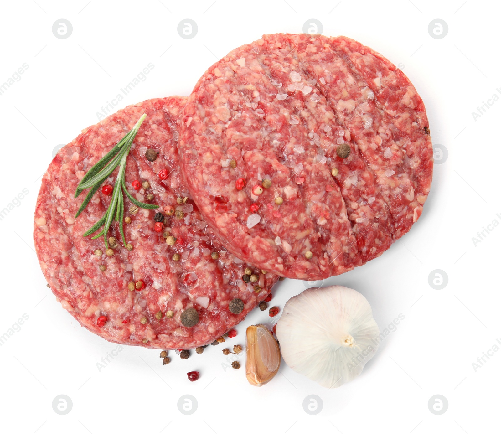 Photo of Raw hamburger patties with rosemary, garlic and spices on white background, top view