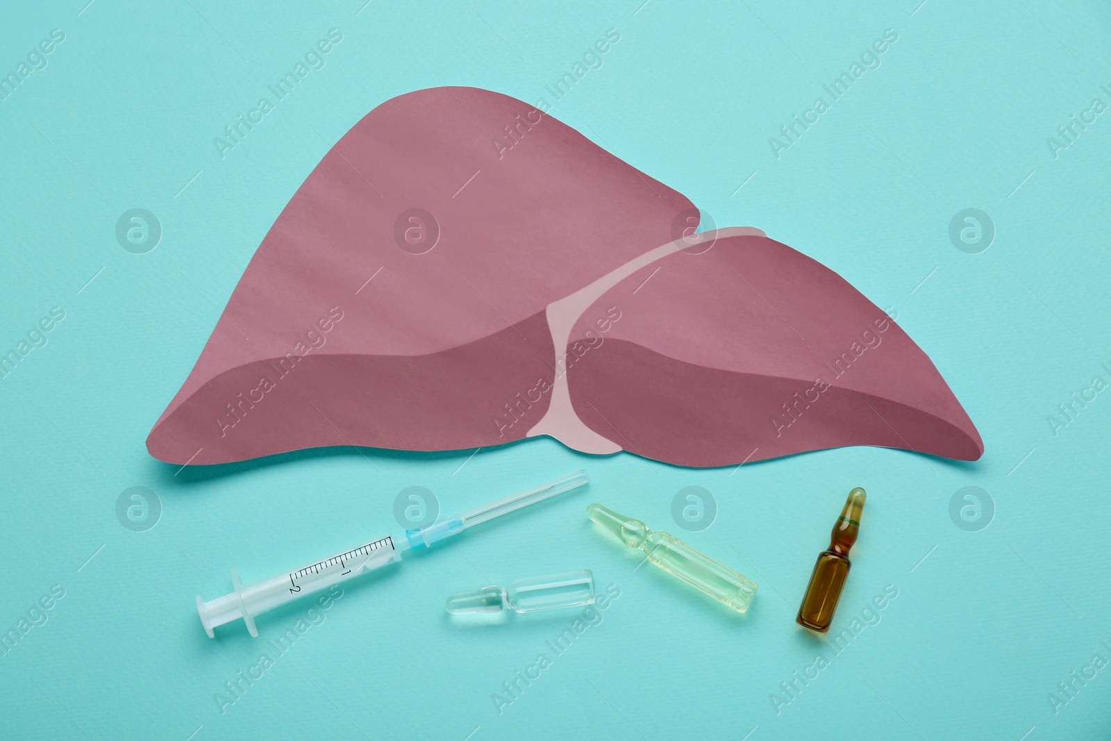 Photo of Paper liver, syringe and vials on turquoise background, flat lay. Hepatitis treatment