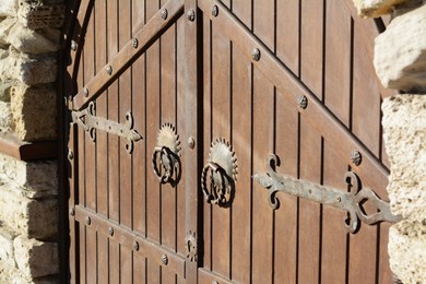 Photo of Entrance of building with old wooden doors outdoors, closeup