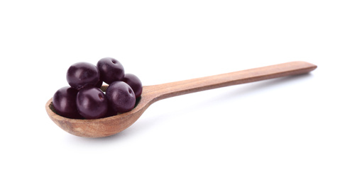 Fresh acai berries in wooden spoon isolated on white