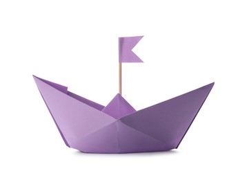 Handmade violet paper boat with flag isolated on white. Origami art