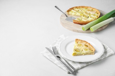 Tasty leek pie served on white table. Space for text