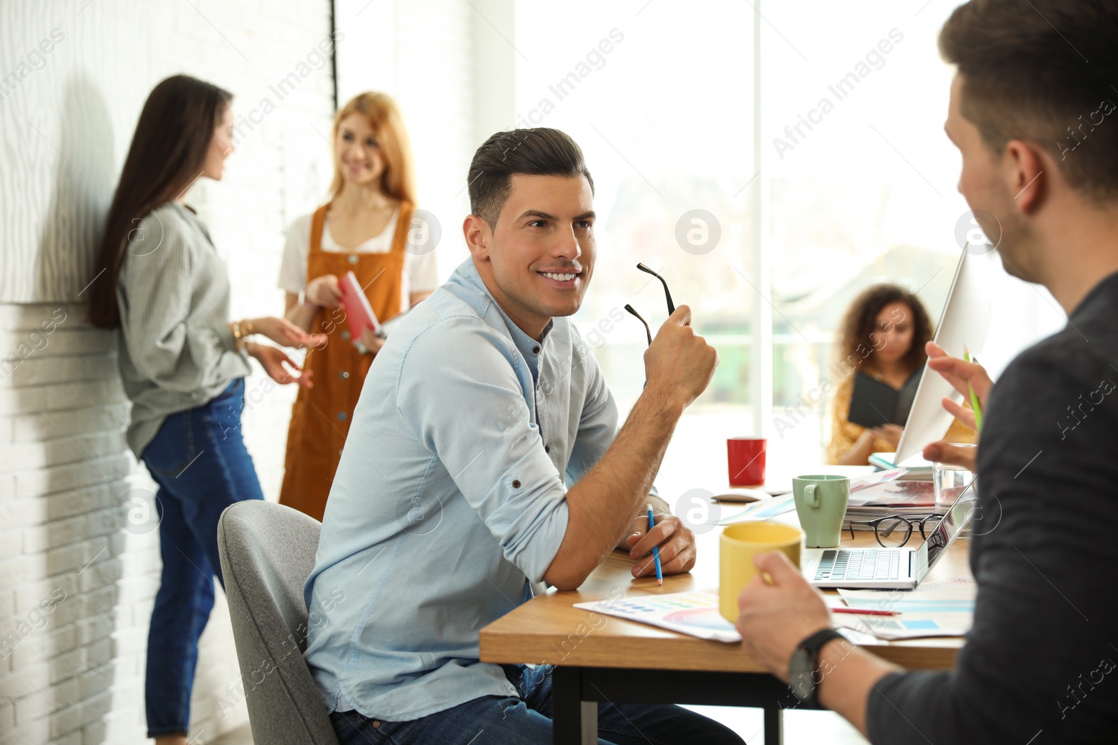 Photo of Team of professional designers working in office