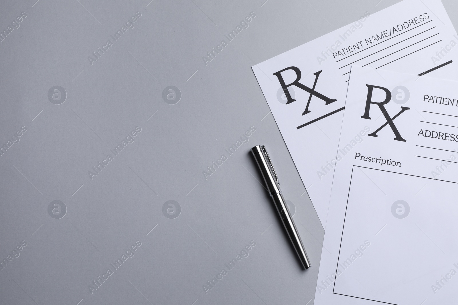 Photo of Medical prescription forms and pen on light grey background, flat lay. Space for text