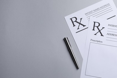 Photo of Medical prescription forms and pen on light grey background, flat lay. Space for text