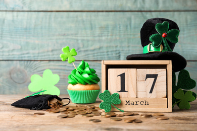 Composition with block calendar on wooden table. St. Patrick's Day celebration