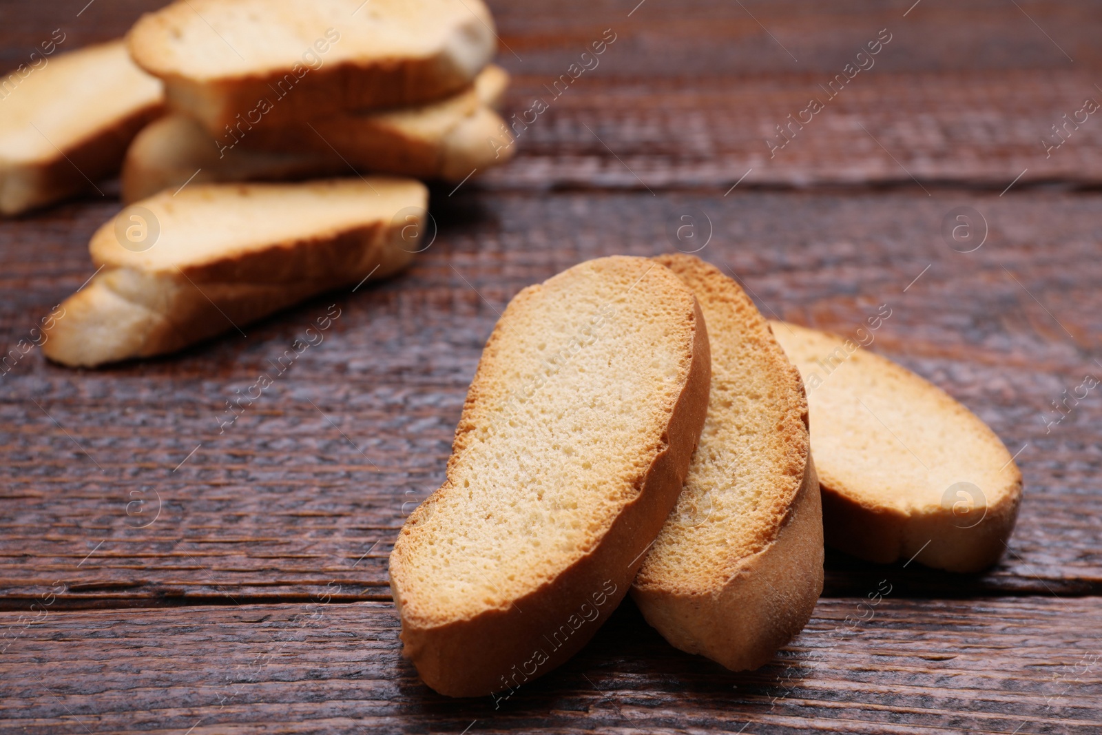 Photo of Tasty hard chuck crackers on wooden table, closeup