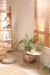 Stylish room interior with shelving unit and white wooden table