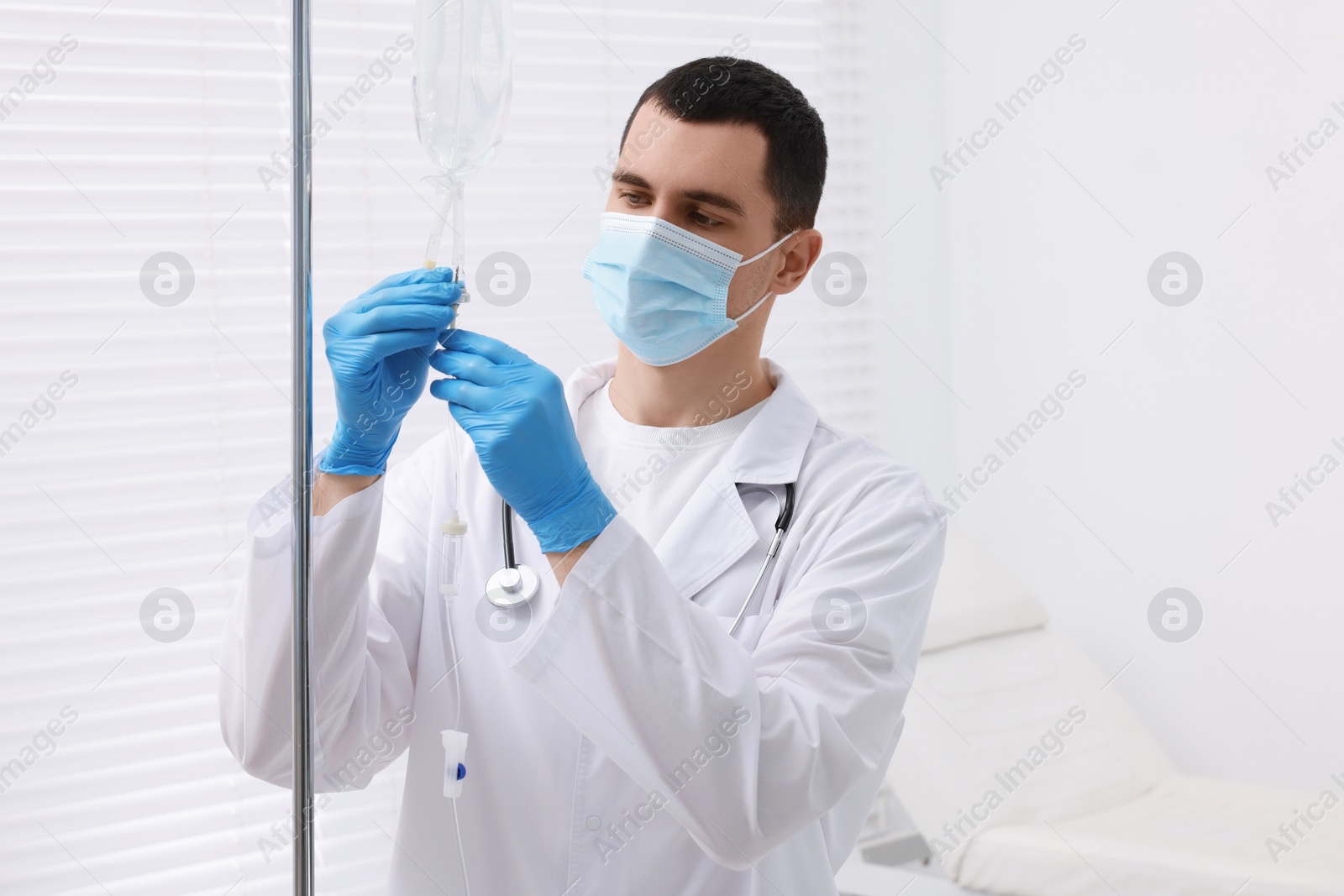 Photo of Doctor setting up IV drip in hospital