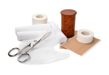 Bandage rolls and medical supplies on white background