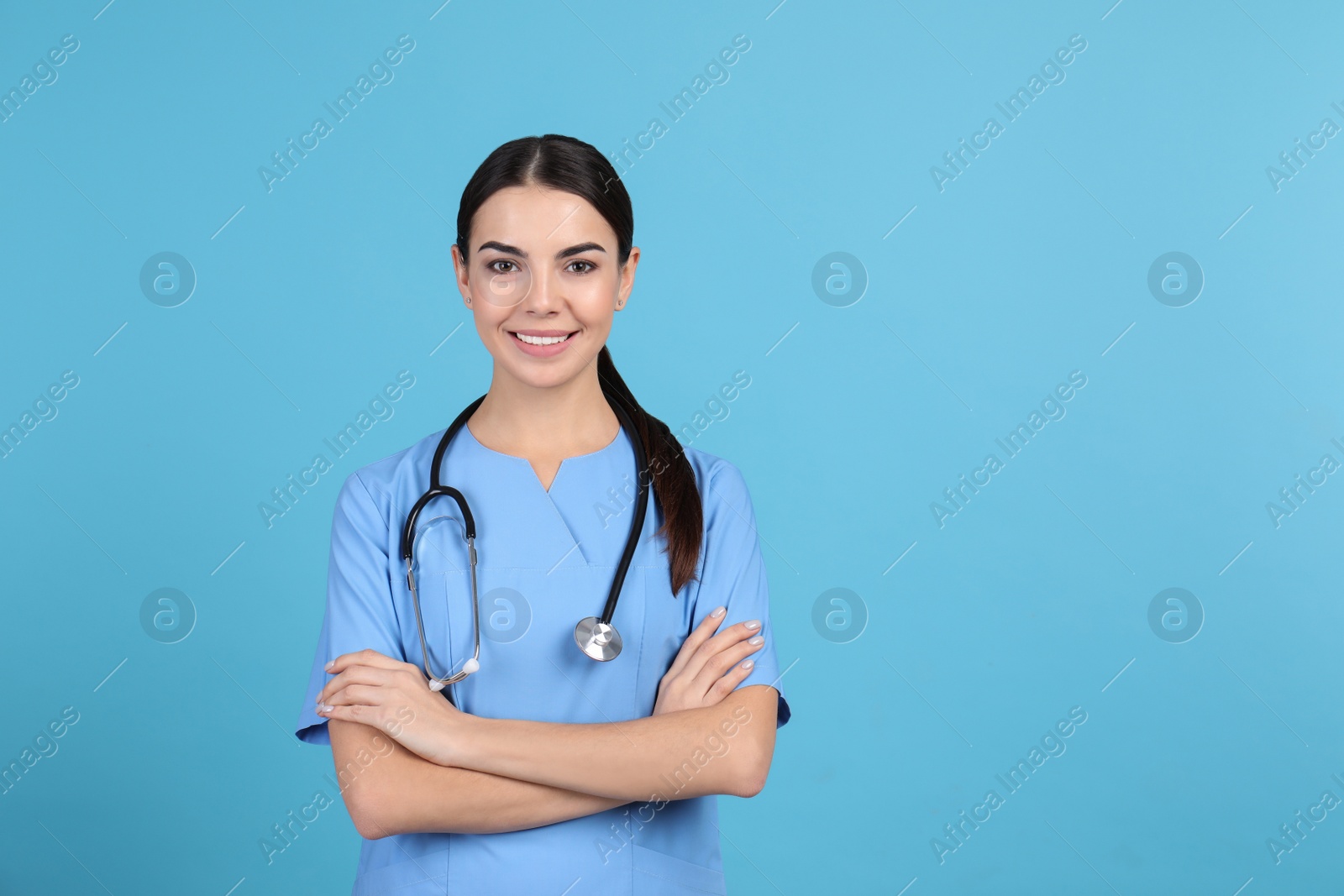 Photo of Portrait of medical assistant with stethoscope on color background. Space for text